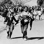 The lifeless body of Hector Pieterson is carried by Mbuyiselo Makhubu