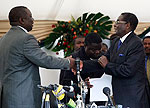 Mugabe and Tsvangirai shaking hands