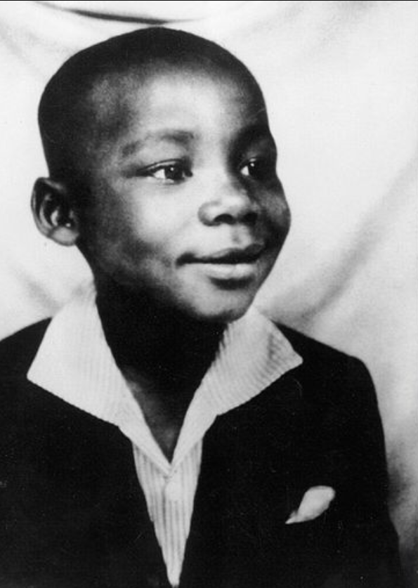 Mandela in Umtata, in his first suit, presented to him by the Paramount Chief of the abaThembu, Jongintaba Dalindyebo. © Mayibuye Centre.