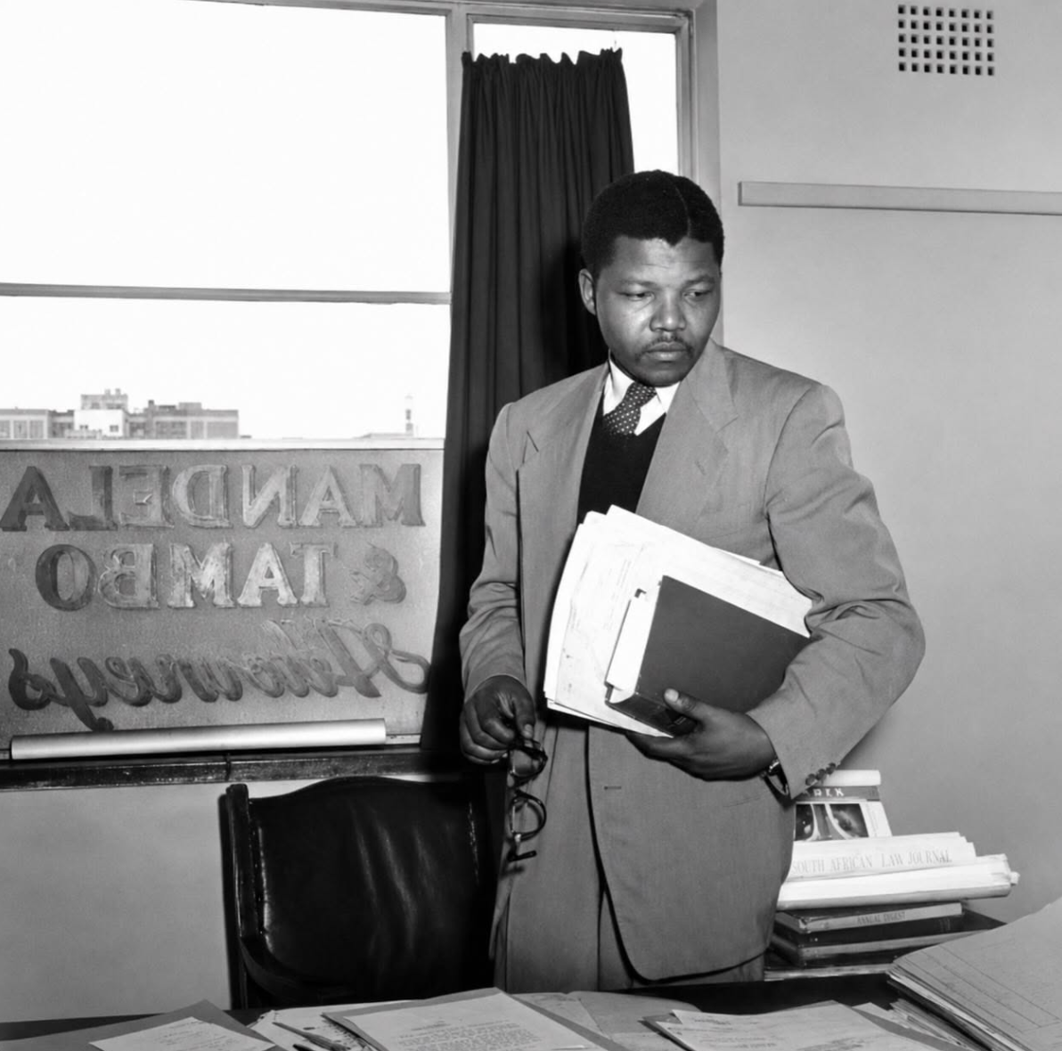 Nelson Mandela pictured in 1952 at the offices of his legal partnership with Oliver Tambo. Photographer: Jürgen Schadeberg. Jurgen Schadeberg / The Drum Archive / african.pictures