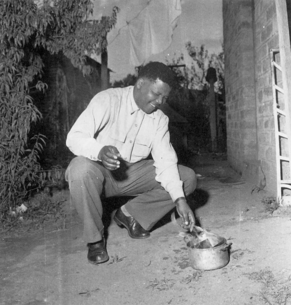 Mandela burns his passbook in an act of Defiance against apartheid pass laws. Photograph: Eli Weinberg, UWC Robben Island Mayibuye Archives.