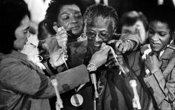 Tutu receives the Martin Luther King Jr. Award for Non-Violence while visiting Atlanta in January 1986. At left is King's wife, Coretta Scott King. King's daughter Christine is behind Tutu, and Tutu's daughter Naomi is at right. AFP/AFP/Getty Images
