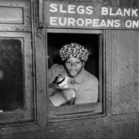 A woman in a train compartment reserved for Whites protesting against Apartheid
