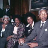 Albertina Sisulu and Winnie Mandela sit with their respective husbands